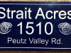 611  wood address sign for "Strait Acres" with snake carving