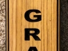 615  vertical wood sign with street address and deer graphic